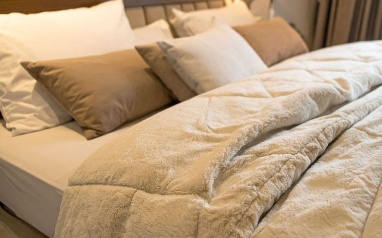 Made bed looking comfortable for a nap